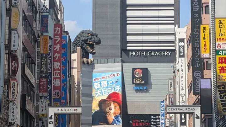 Godzilla head overlooks a paddington poster in Tokyo