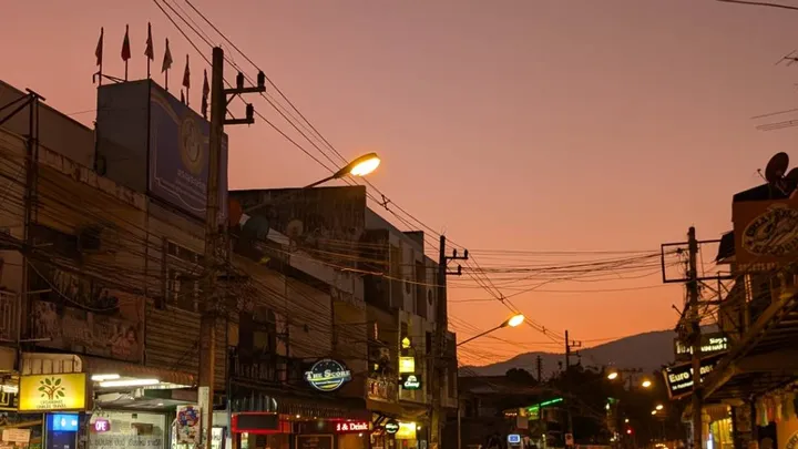 Sun setting over a street in Chiang Mai