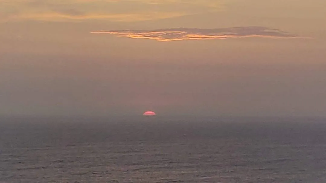 The sun setting over the pacific ocean