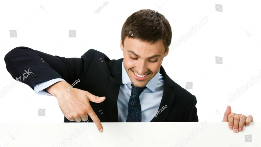 A man in a suit looking down and pointing