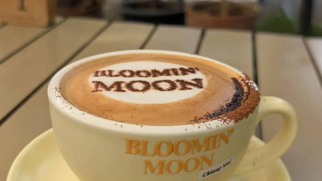A cup of coffee with the name Bloomin&#x27; Moon spelled out on it