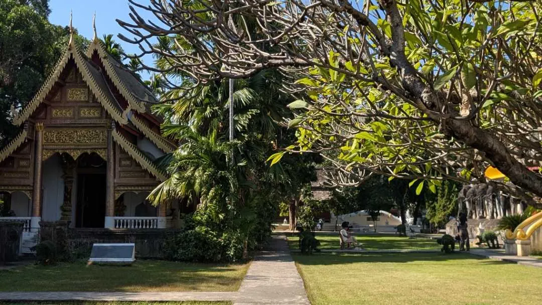 A lawn with a small temple on it