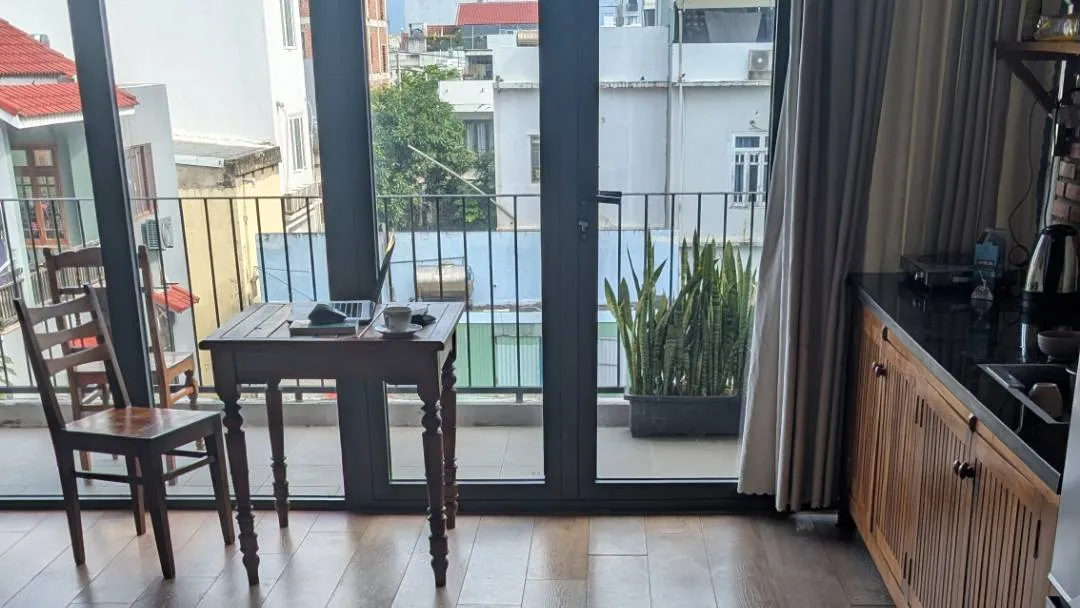 A laptop on a table by a window