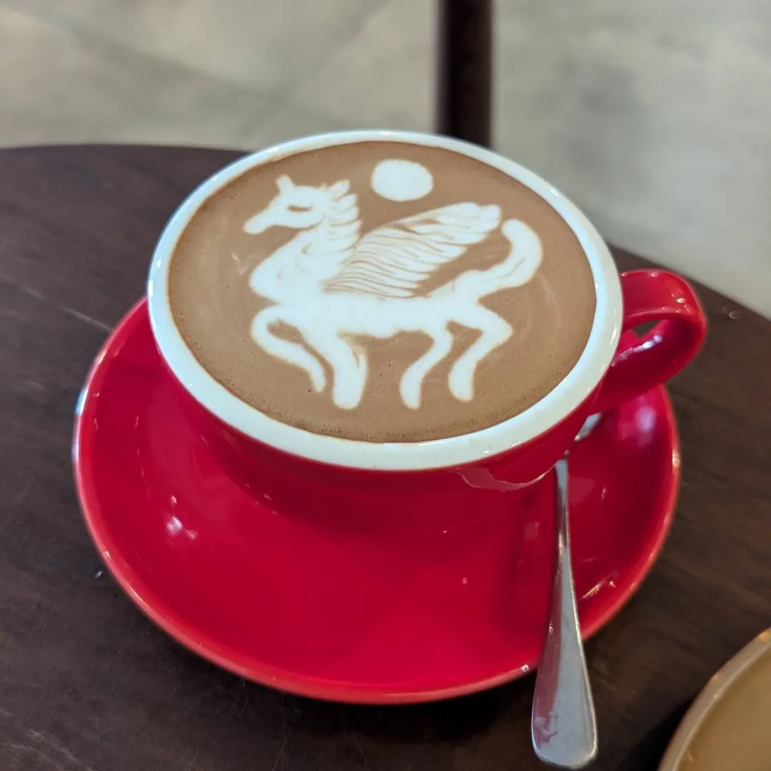 A unicorn design made from the cream in a coffee mug