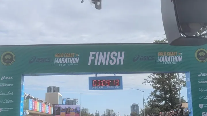 A finish sign for a marathon with a race timer underneath it