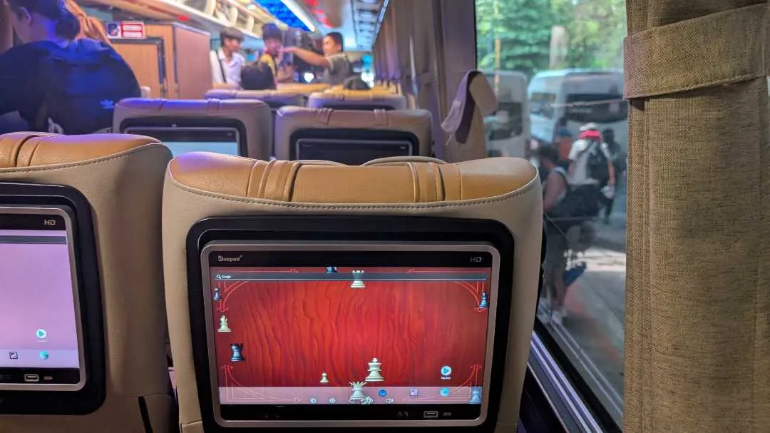A TV screen on a bus showing a chess screensaver