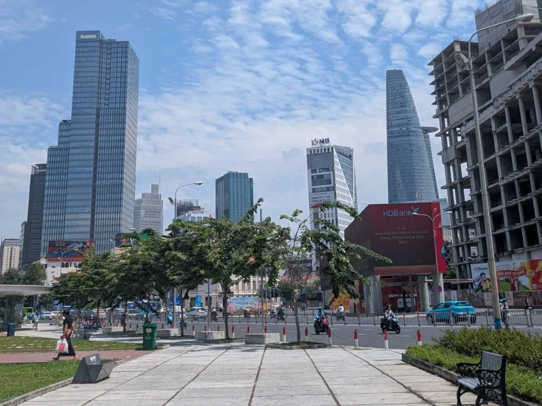 A park in daytime with buildings in the background