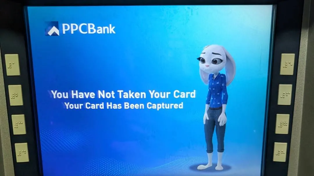 A photo of an ATM with the screen denoting that the card has been swallowed