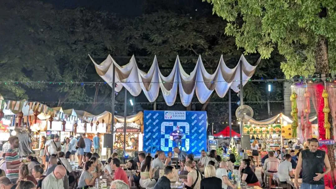 A food market with performers in the background