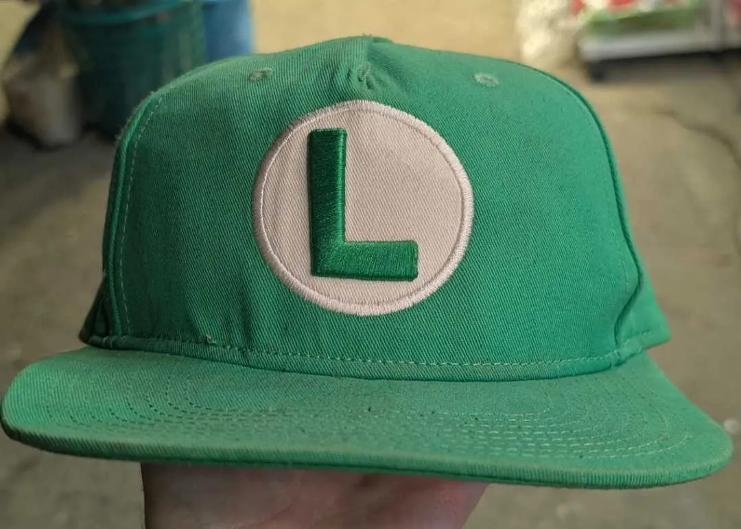 A green snapback cap with the L for Luigi
