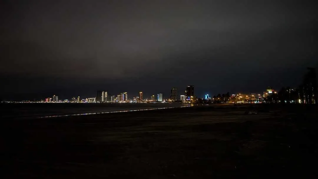 A picture looking over at Da Nang beachside buildings at night
