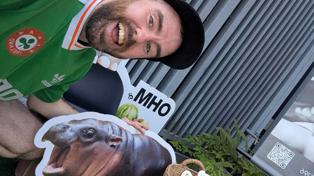 Me beside a picture of Moo Deng
