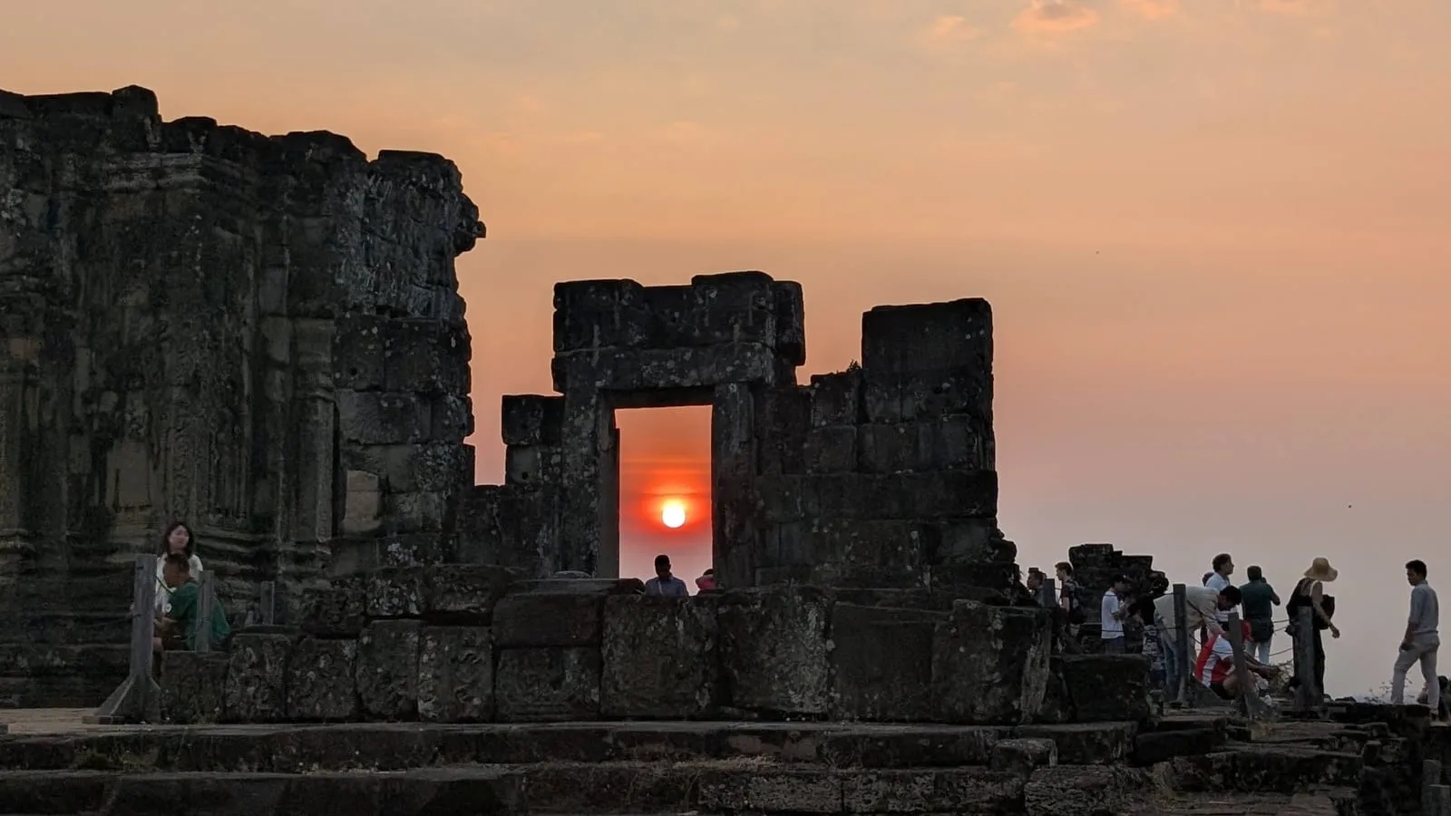 The sun setting at Phnom Bakheng, a temple beside Angkor Wat