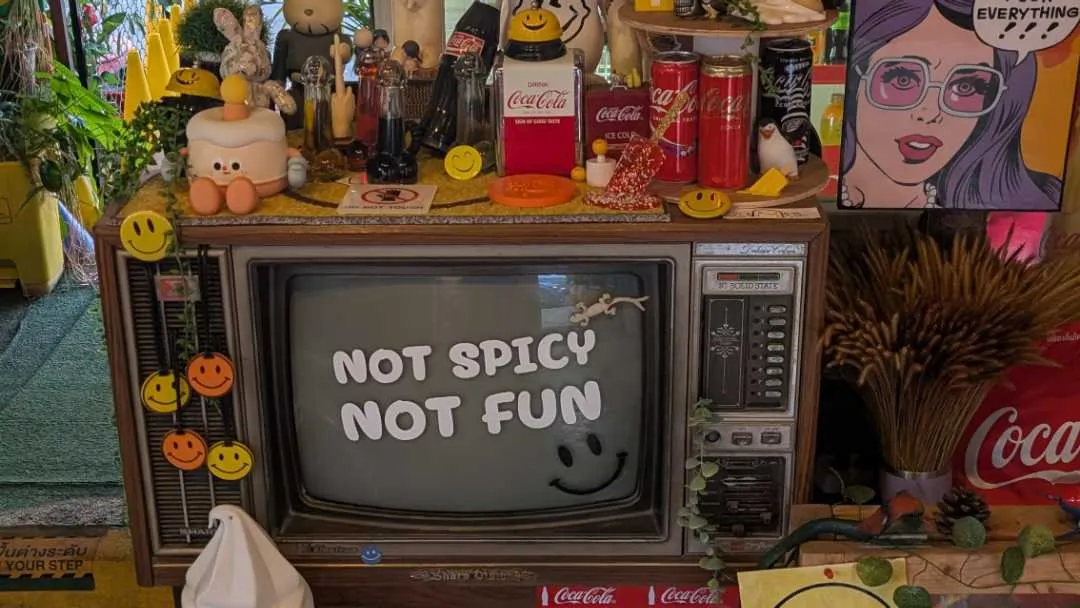 A restaurant with quirky paraphonaila; lots of smiley faces and a TV
