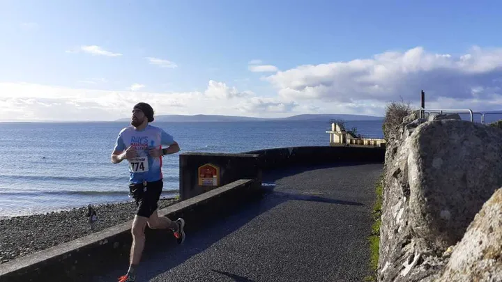 Me running by Blackrock Tower during the Galway Bay Marathon