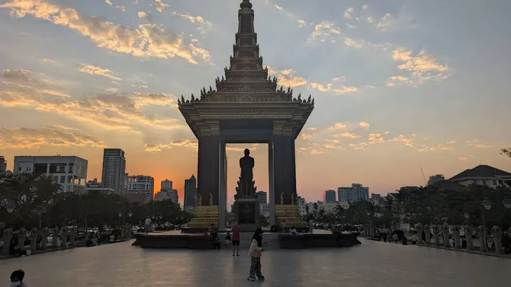 The Independence Monument in Phnom Penh from behind with the sun setting