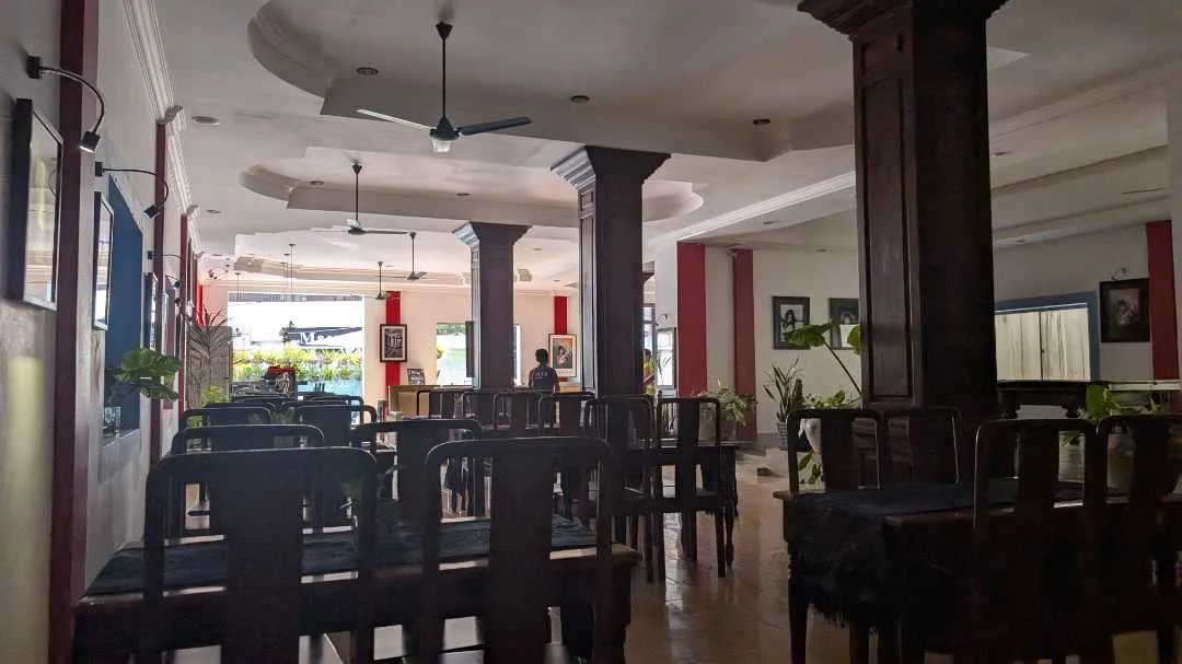 A quiet restaurant with lots of chairs in the foreground