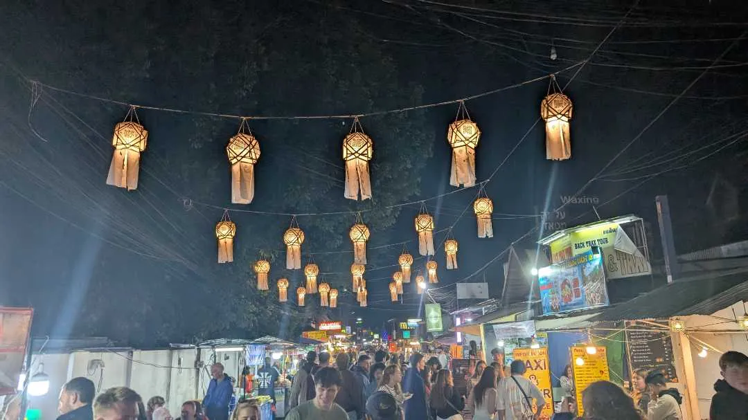 Pai Walking Street at night with people walking under the lanterns that adorn the street