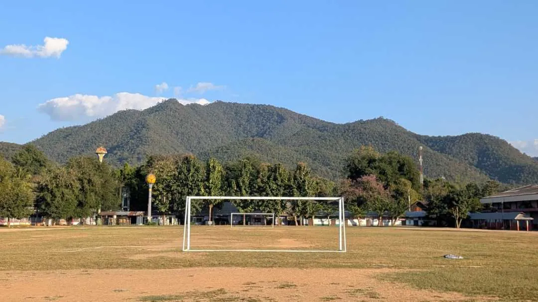 A football pitch with a mountain in the background