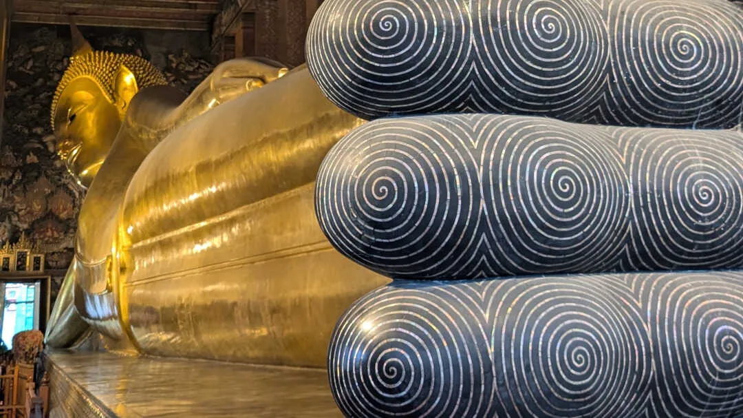 The reclining buddha statue photo taken at an angle from the feet